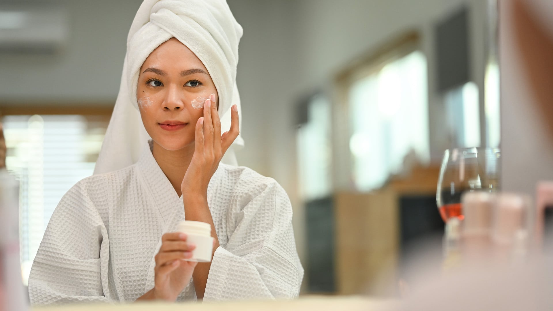 Beautiful Woman Applying Moisturizer